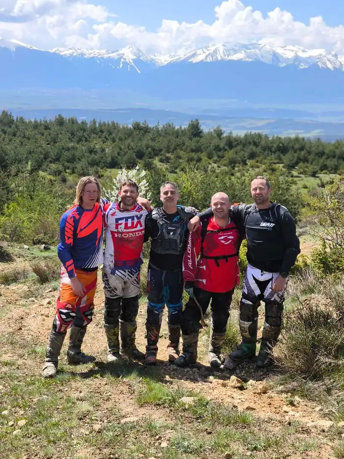 Guided group crossing a forest trail in the Pirin Mountains